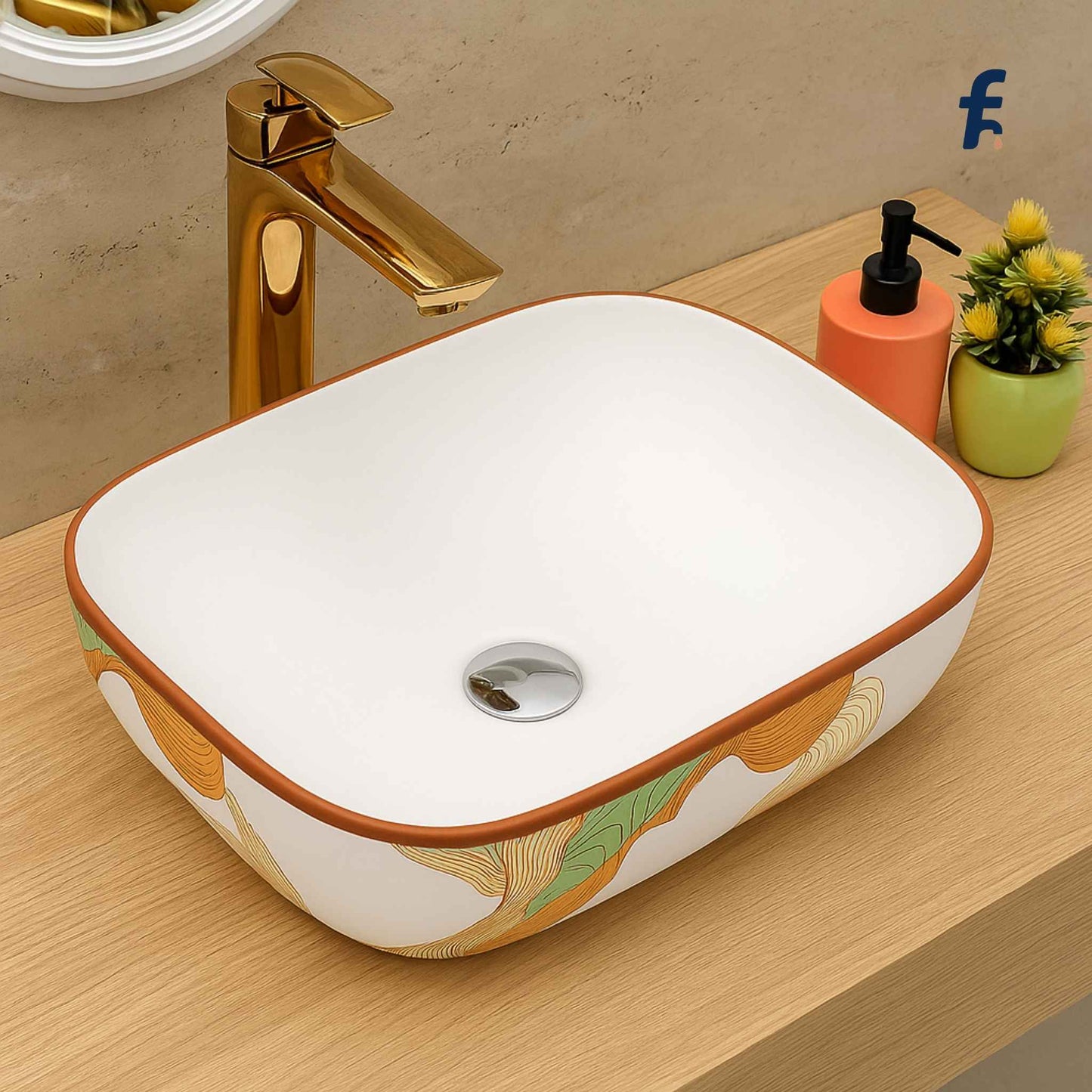 Decorative bathroom sink with gold faucet on a wooden surface