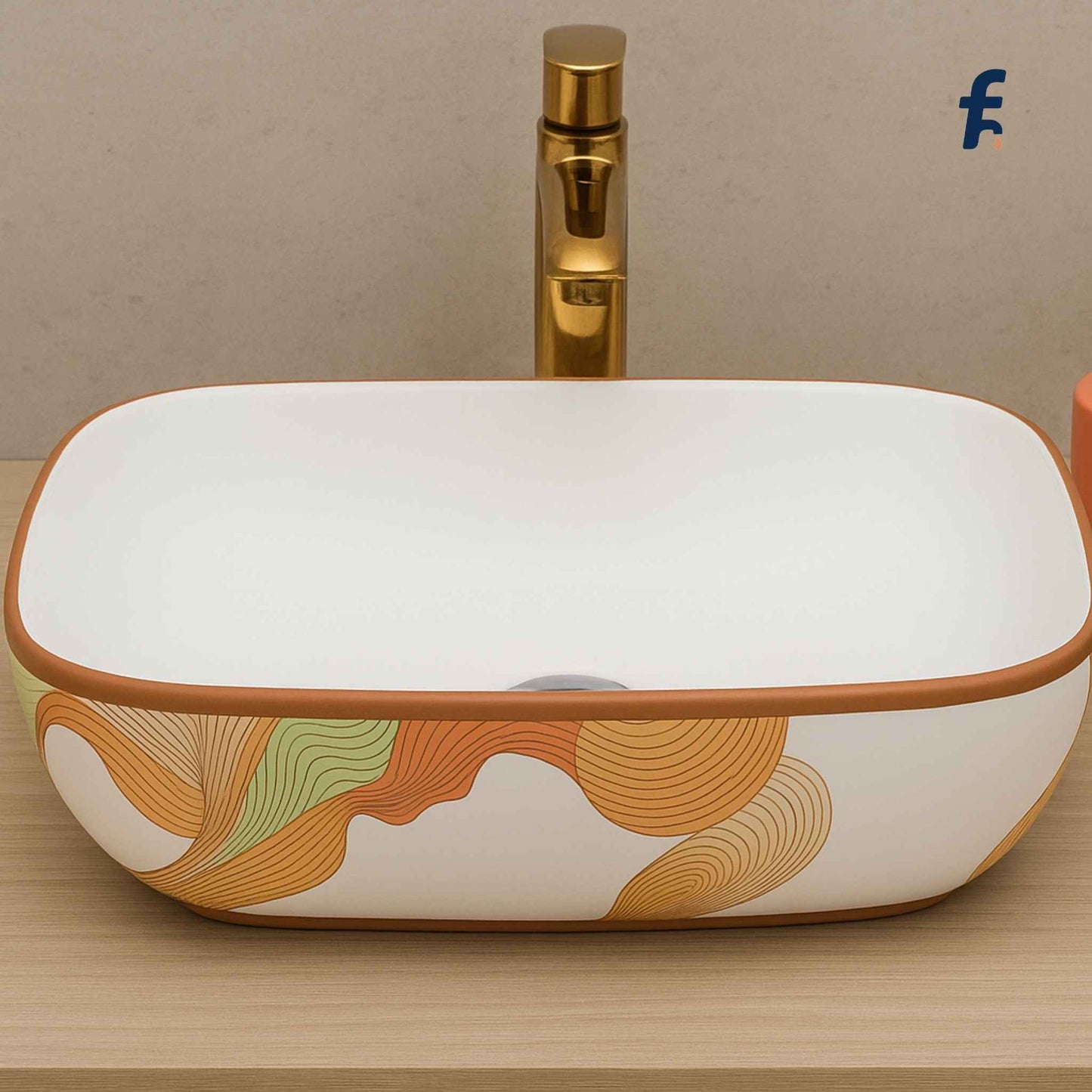 Rectangular ceramic sink with artistic design and gold faucet on a beige background