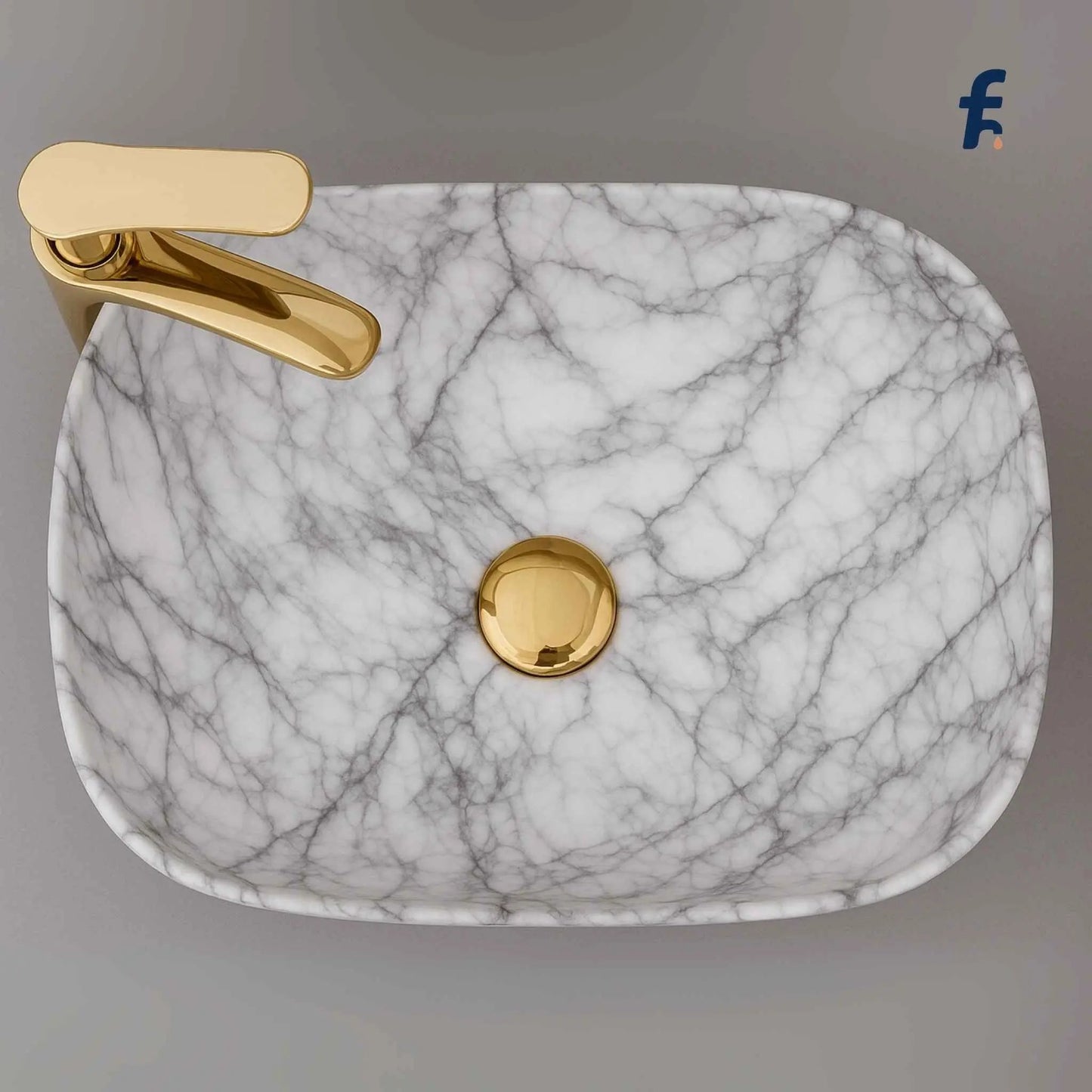 Marble-patterned sink with gold faucet on a neutral background, Top angle view of rectangular white marble table top basin for bathroom – ceramic finish.