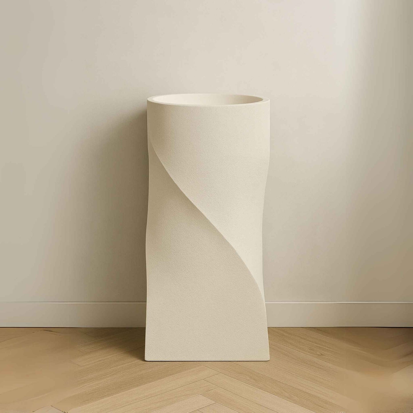Front view of textured beige sculptural pedestal wash basin
