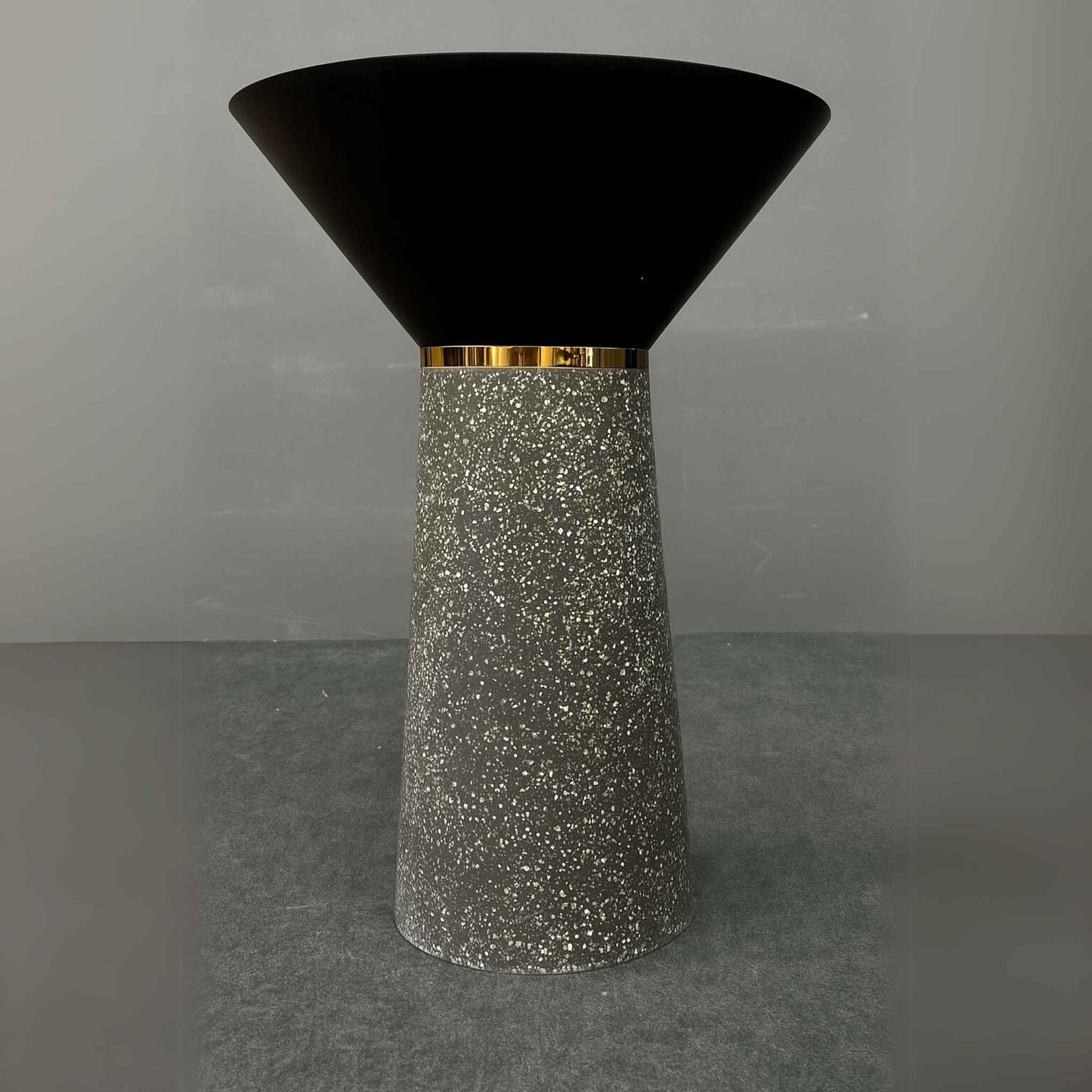 Front view of black cone pedestal basin with granite-textured base