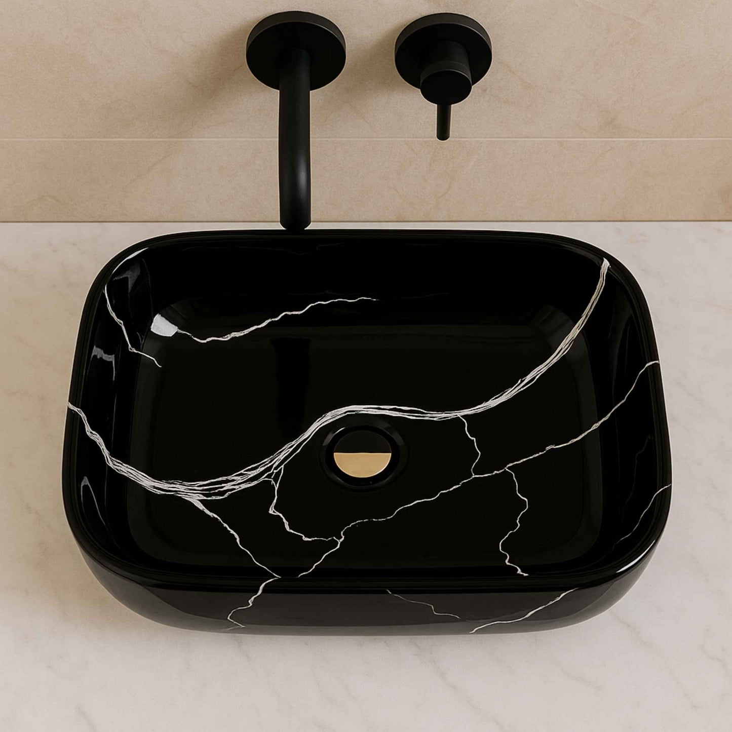 Top view of rectangular black marble bathroom sink with white vein design and wall-mounted faucet