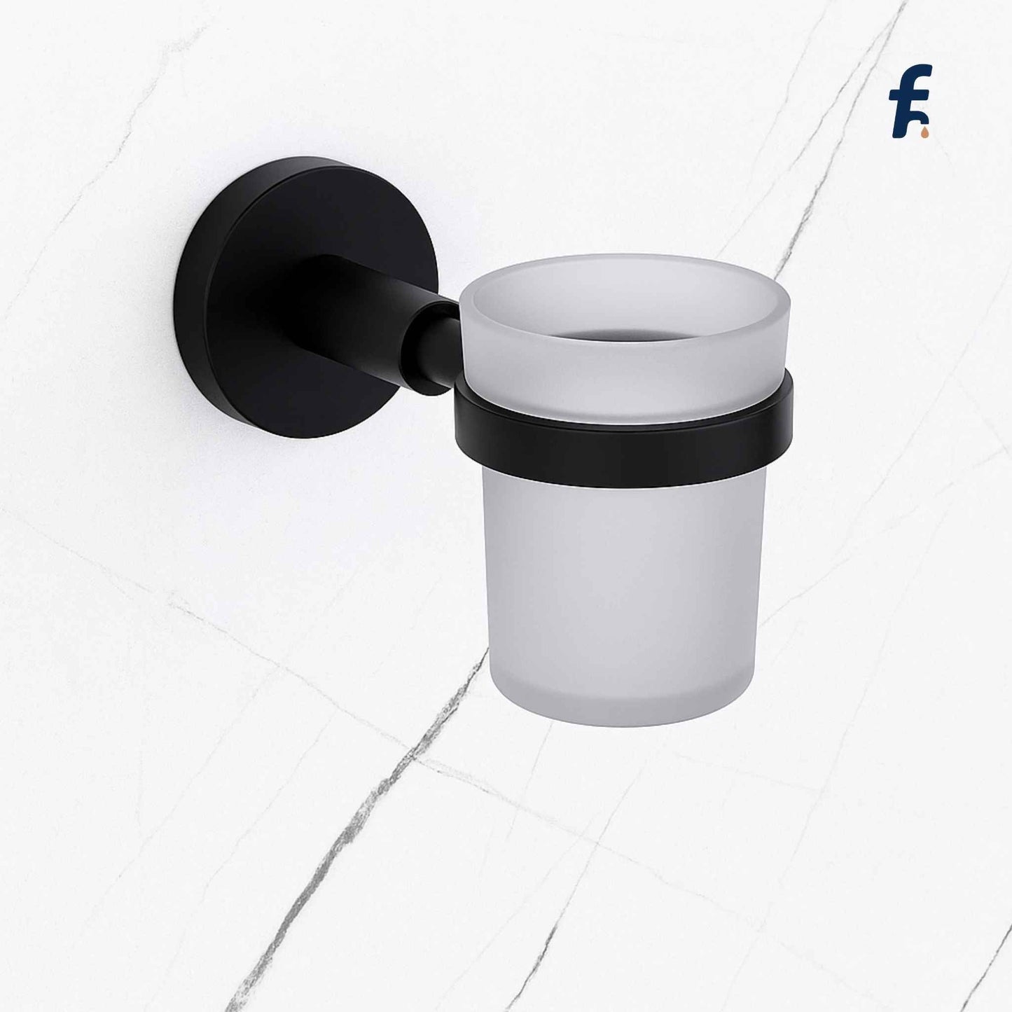 Black wall-mounted toothbrush holder with a white cup on a light gray background. Gold wall-mounted tumbler holder with frosted glass cup in premium brass finish for modern bathrooms