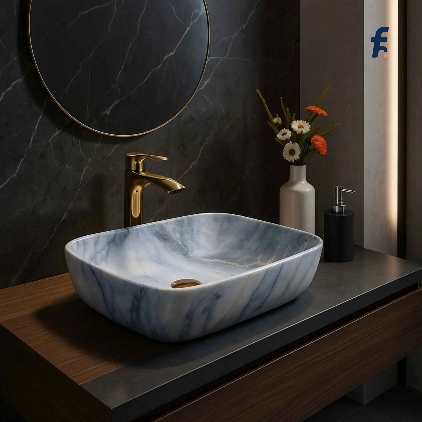 Marble-patterned sink on a wooden vanity with gold faucet and decorative elements. Top angle view of rectangular ceramic table top wash basin with blue grey marble pattern