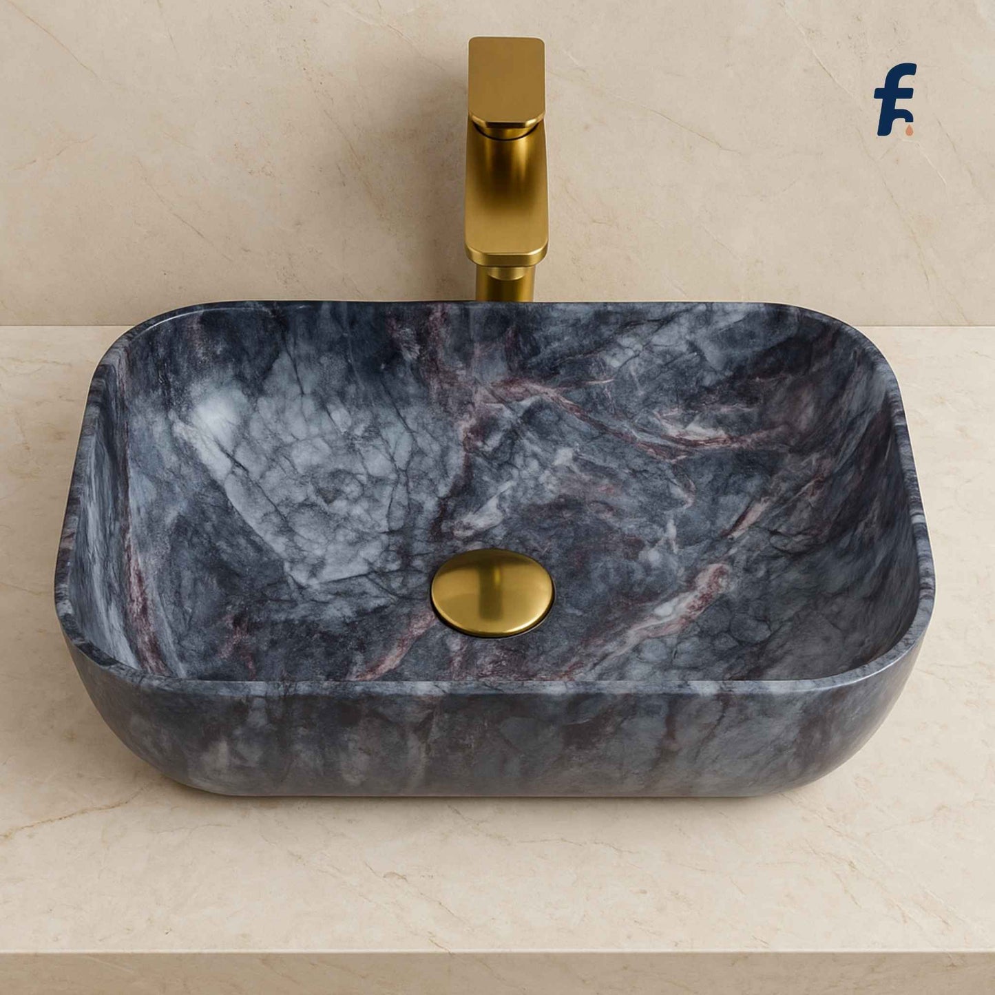 Marble-patterned sink with gold faucet on a beige background
