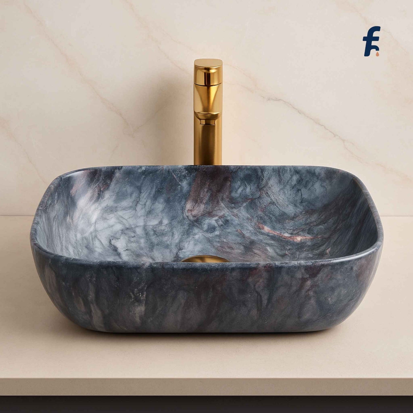 Marble-patterned sink with gold faucet on a beige background