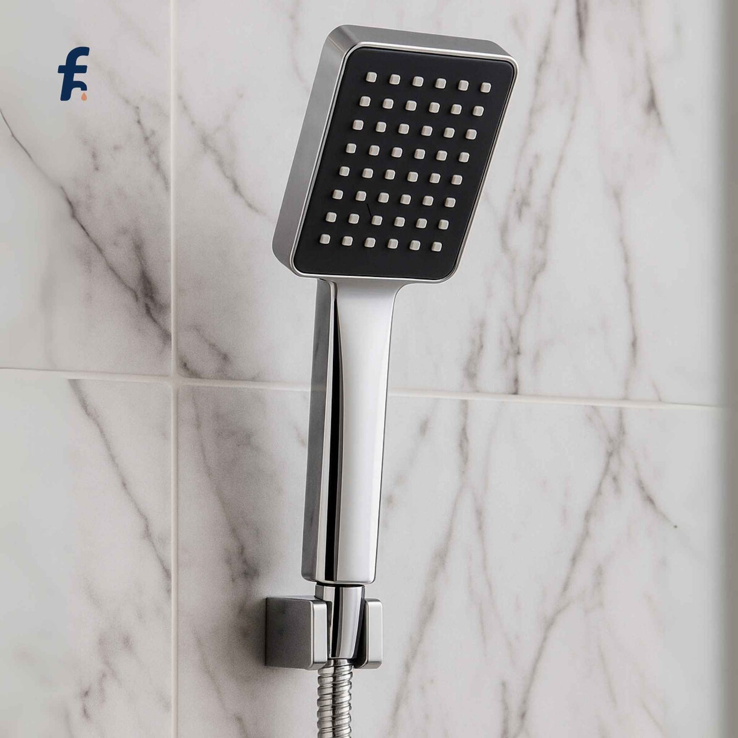 Square shower head attached to a hose on a marble tiled wall, Close-up of handheld chrome shower head placed in a luxury setting