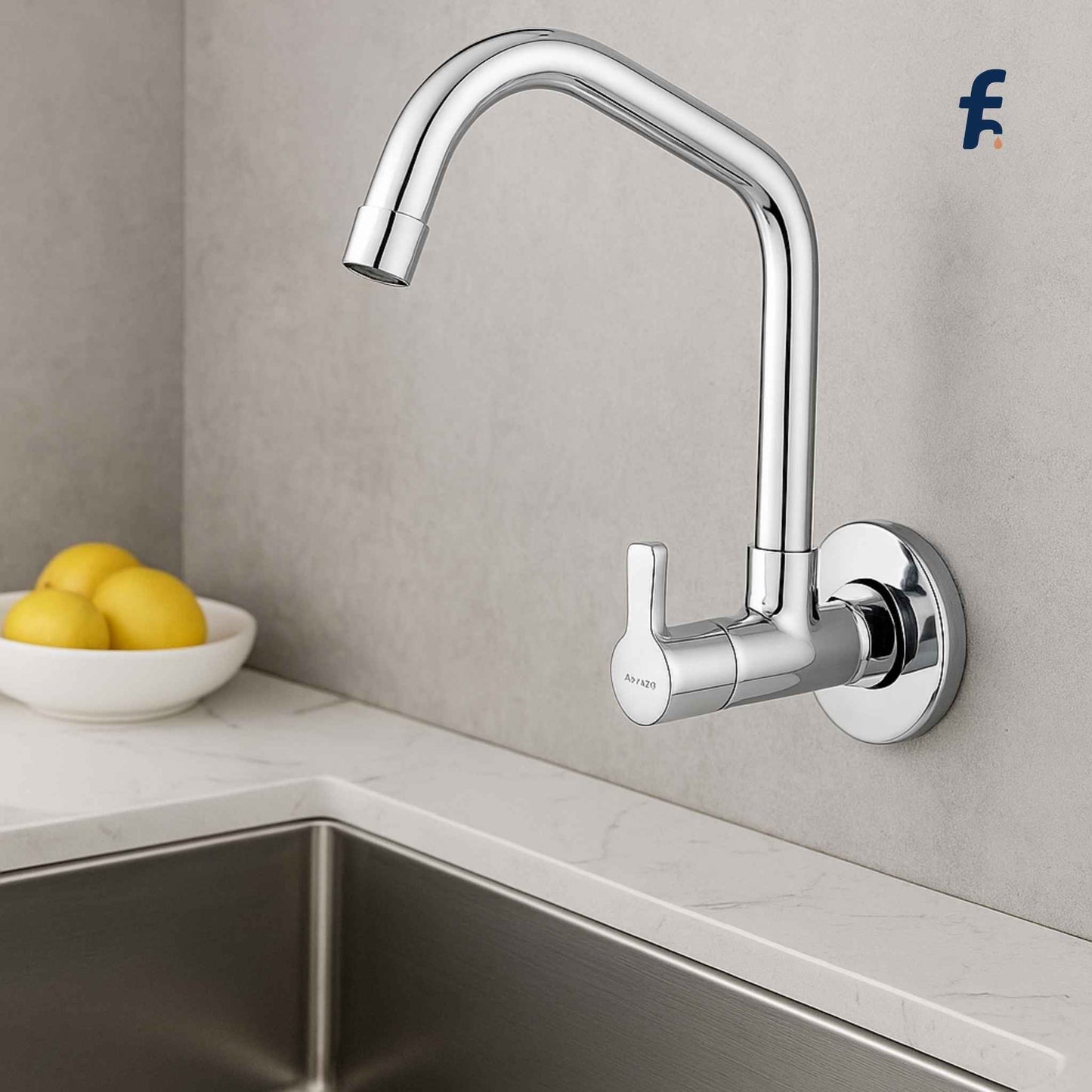 Modern kitchen faucet mounted on a gray wall above a sink with a bowl of lemons. Chrome sink cock with extended swinging spout and wall flange – affordable wall-mounted kitchen faucet from StreamLite Series"