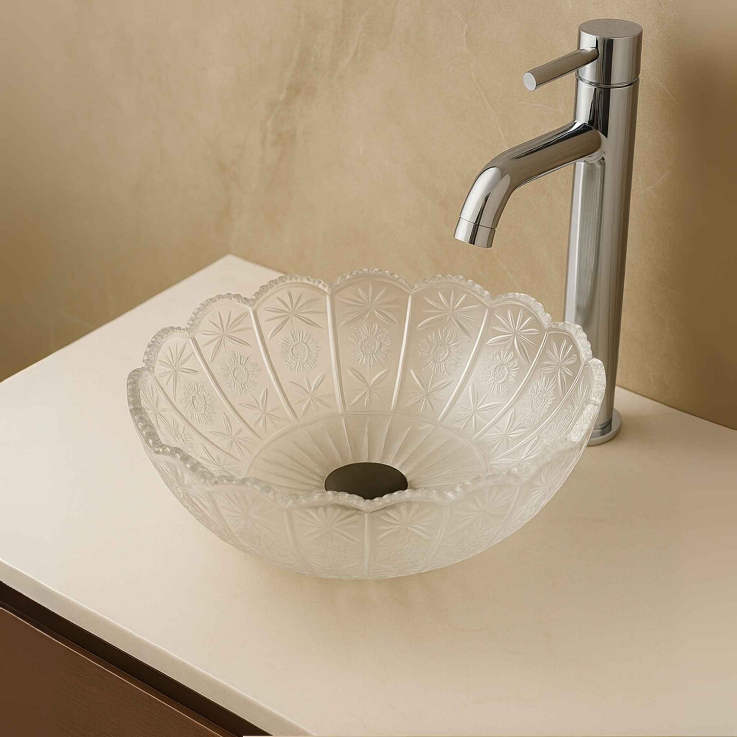 Close-up of floral embossed pattern on crystal clear bathroom glass wash basin