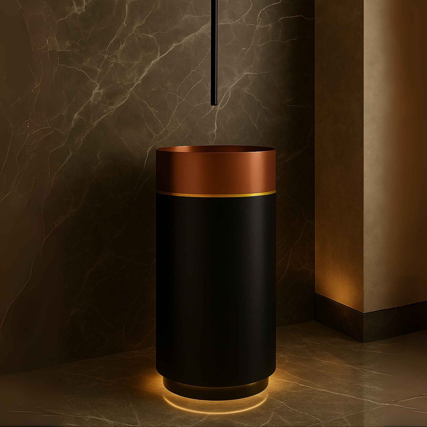 Close-up of rose gold pedestal washbasin with brass underglow lighting