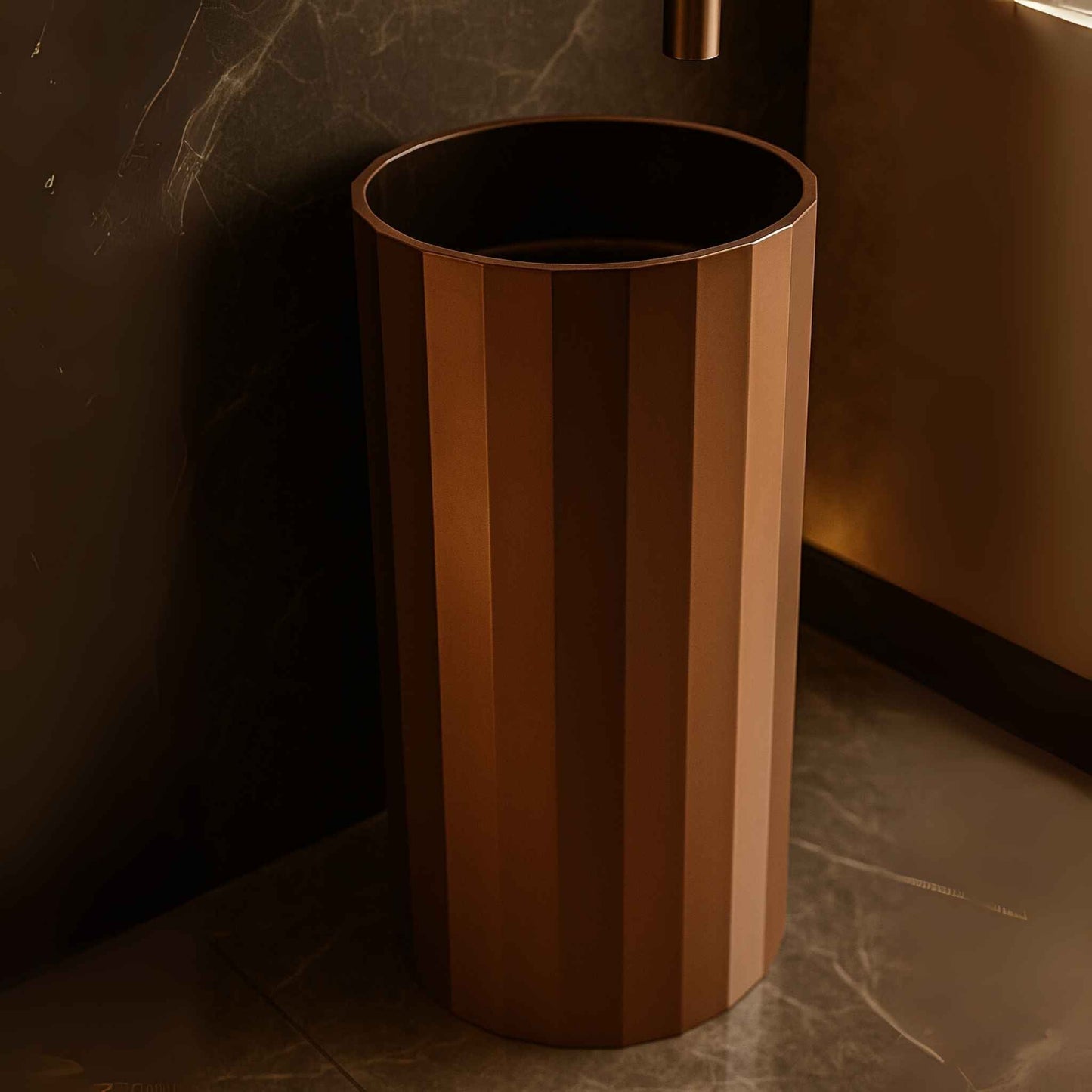 Close-up of copper pedestal sink showing detailed fluted metal texture