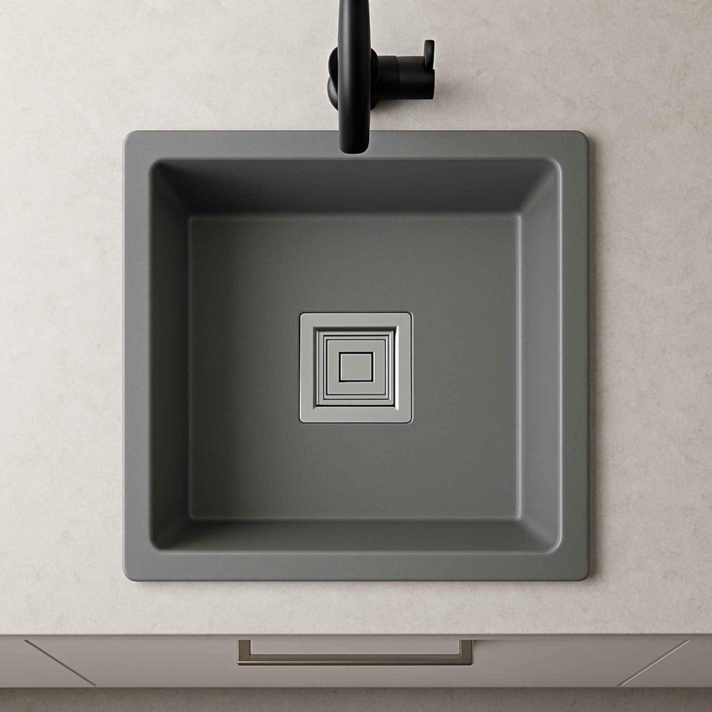Top angle of Culinox Series grey kitchen sink installed in marble countertop with black faucet
