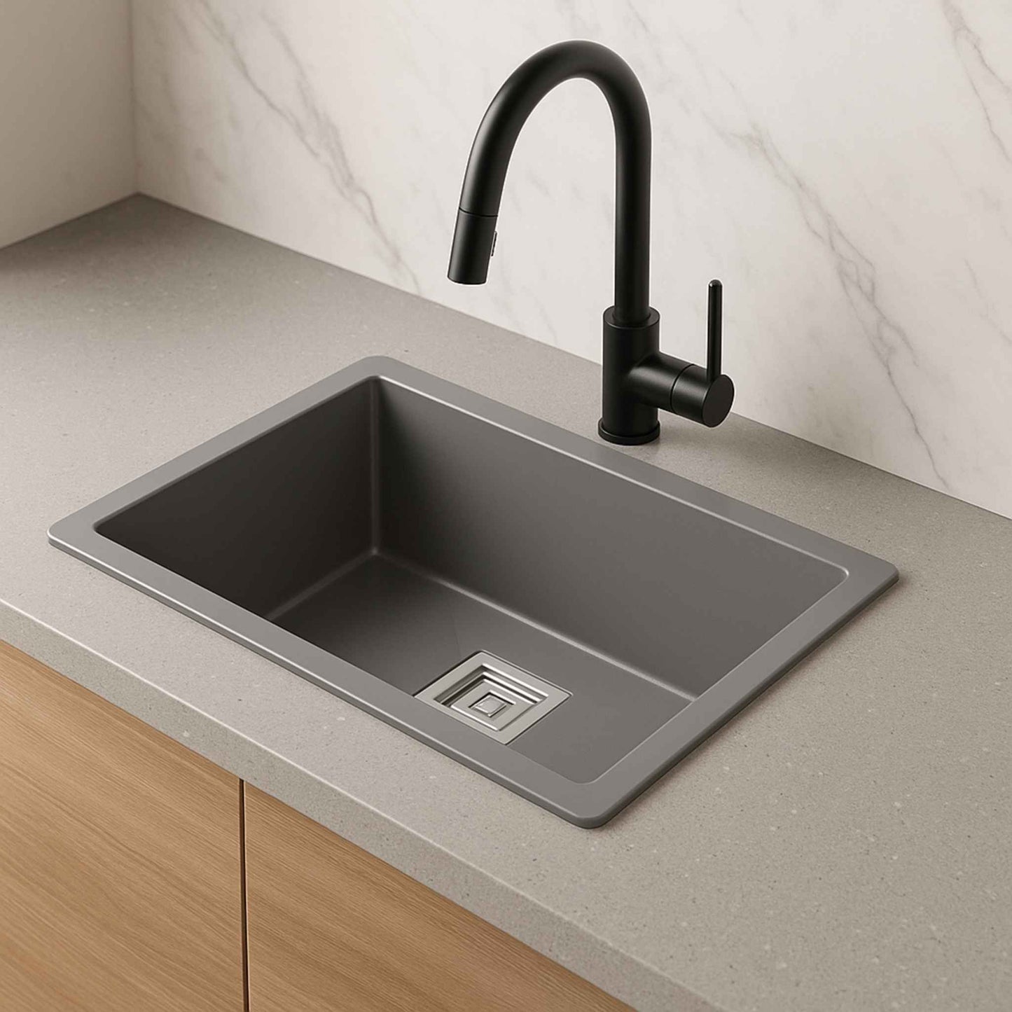 Side profile of matte grey metallic sink with compact depth and black faucet.