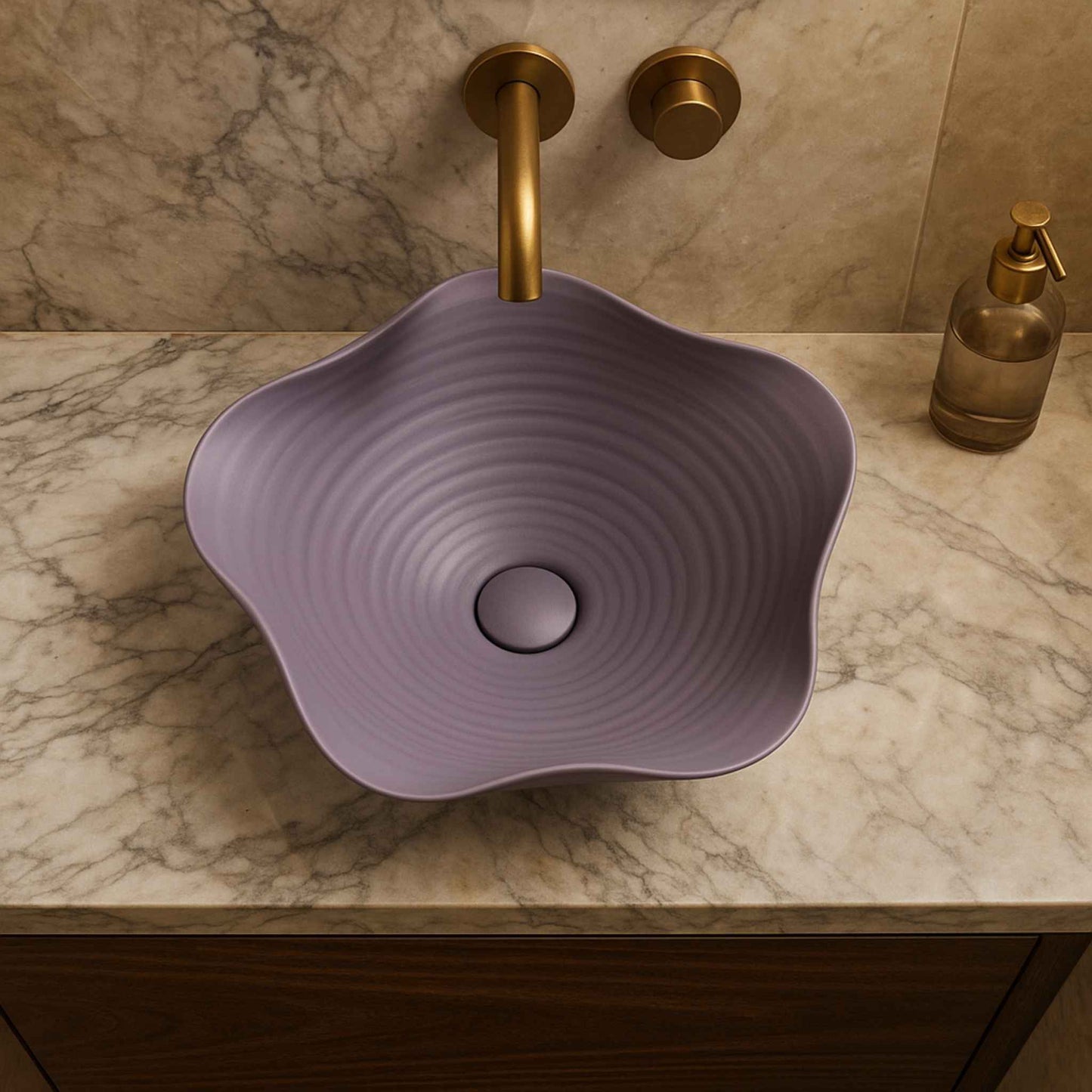 Purple sink with gold faucet and soap dispenser on a marble countertop