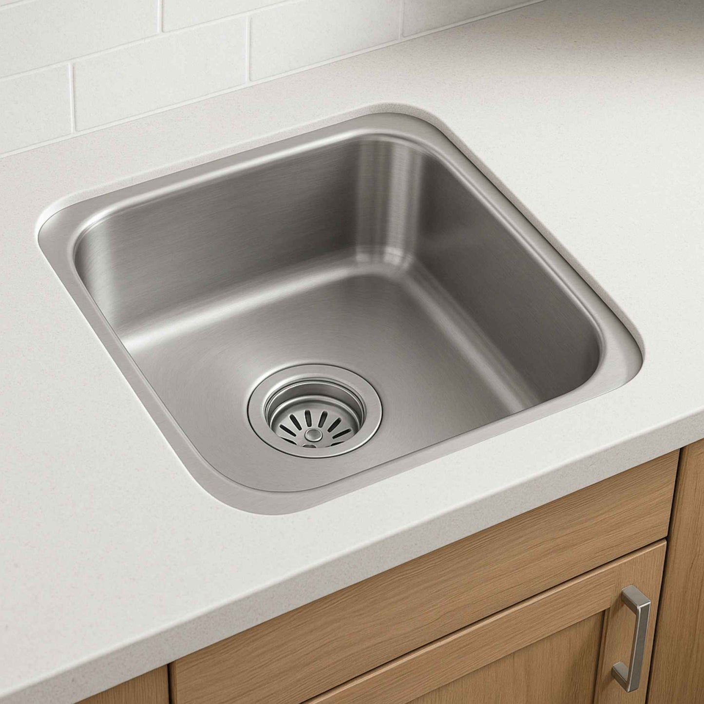 Single bowl stainless steel kitchen sink installed in white countertop for modern Indian kitchen