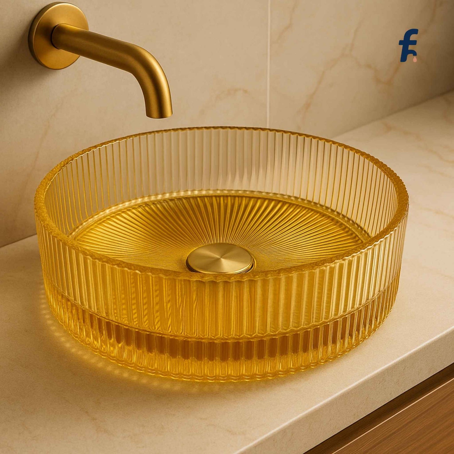 Gold glass fluting sink with a matching faucet on a light-colored countertop.