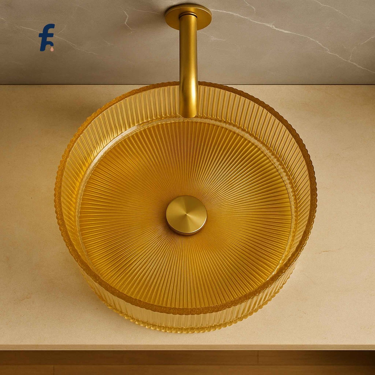 Gold glass fluting sink on a beige countertop with a marble wall background for modern indian homes