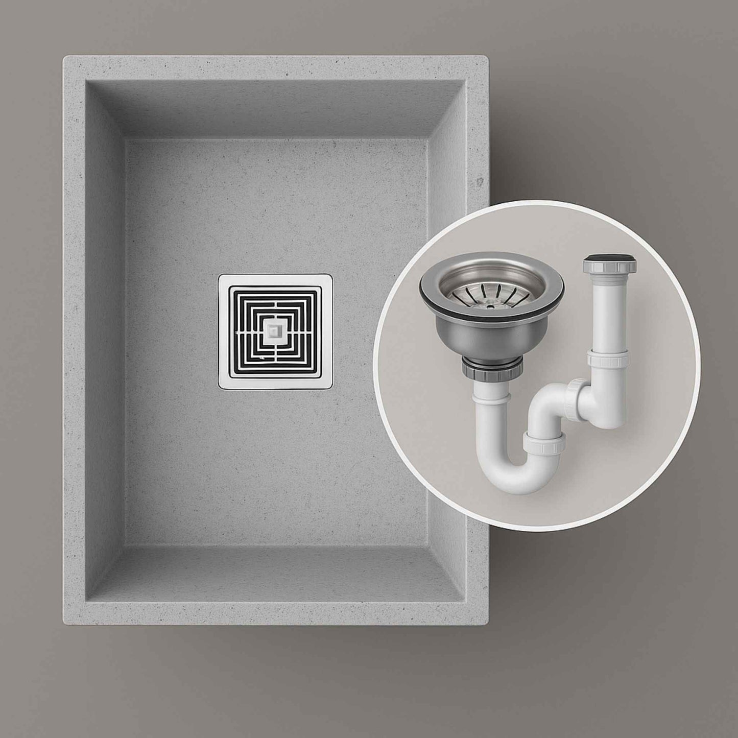 Grey kitchen sink with included waste coupling and drain pipe shown in circular callout