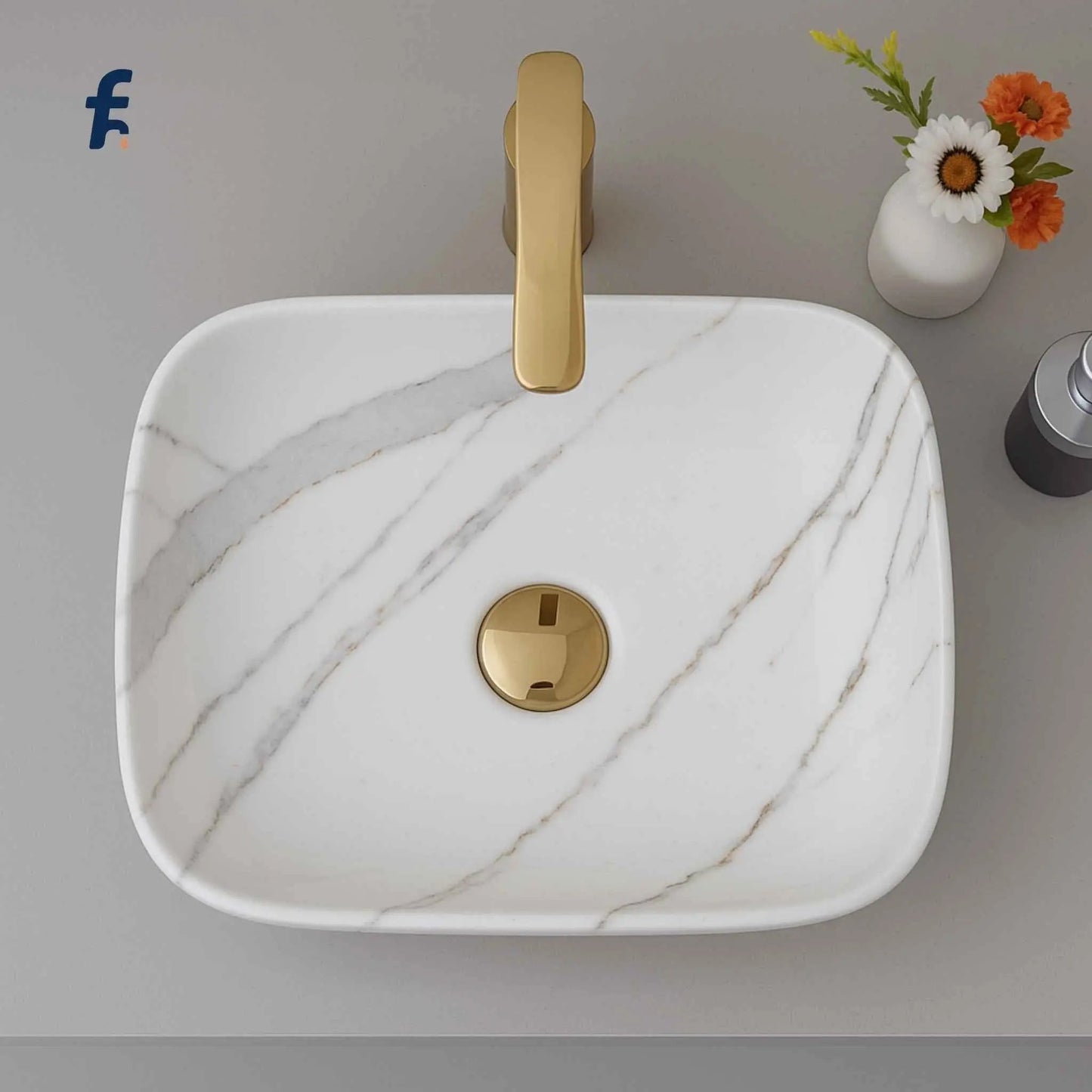 Marble-patterned sink with gold faucet and decorative flowers on a gray surface, Top view of white ceramic table top wash basin with grey marble pattern – 18x13 size