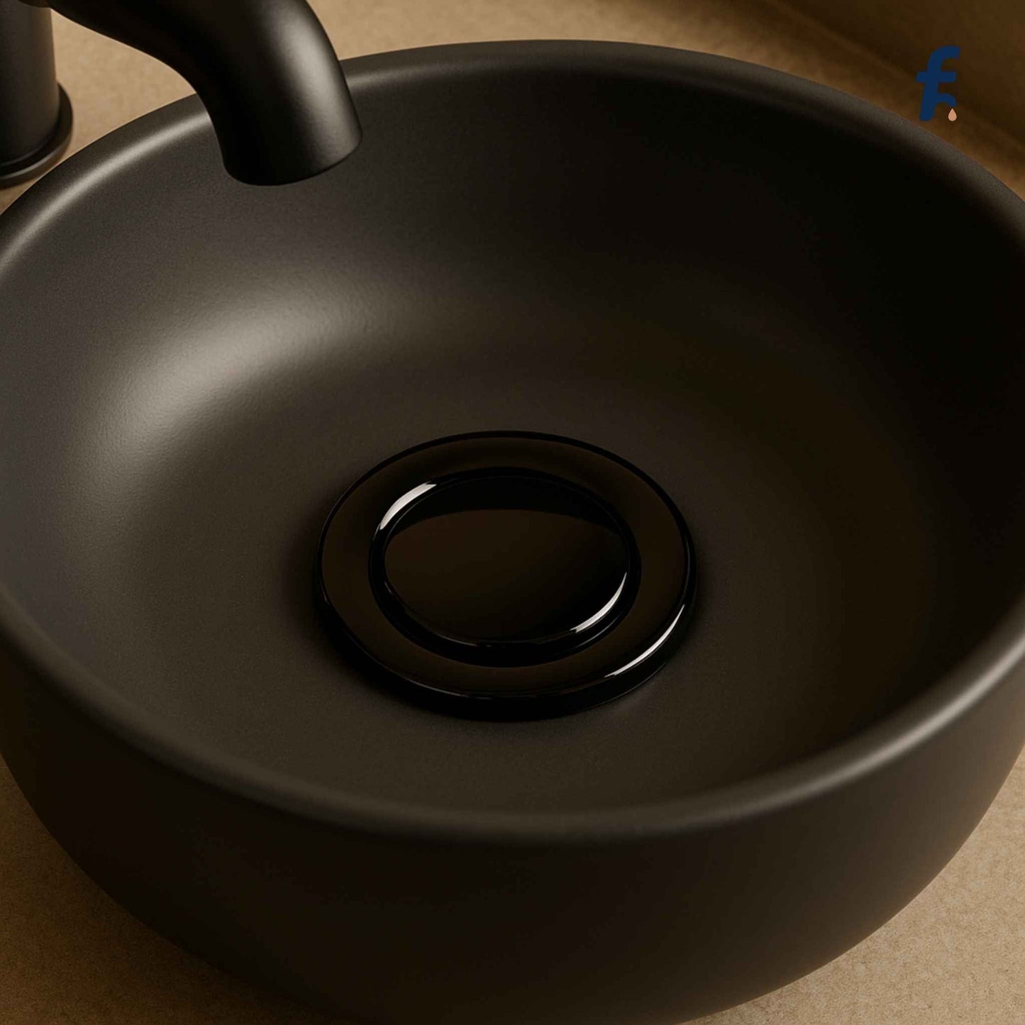 Black drain stopper installed in ceramic designer basin