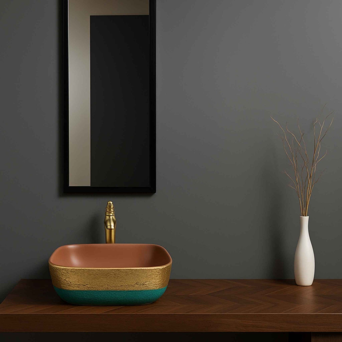 Bathroom setup with a square sink, gold faucet, and white vase against a dark gray wall.