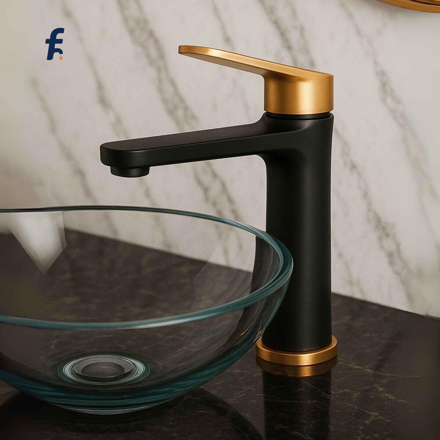 Black and gold faucet on a glass sink with marble background