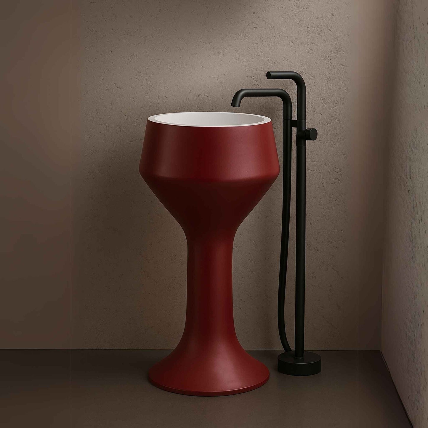 Hourglass red pedestal sink in front of Italian marble wall with wall-mounted black faucet