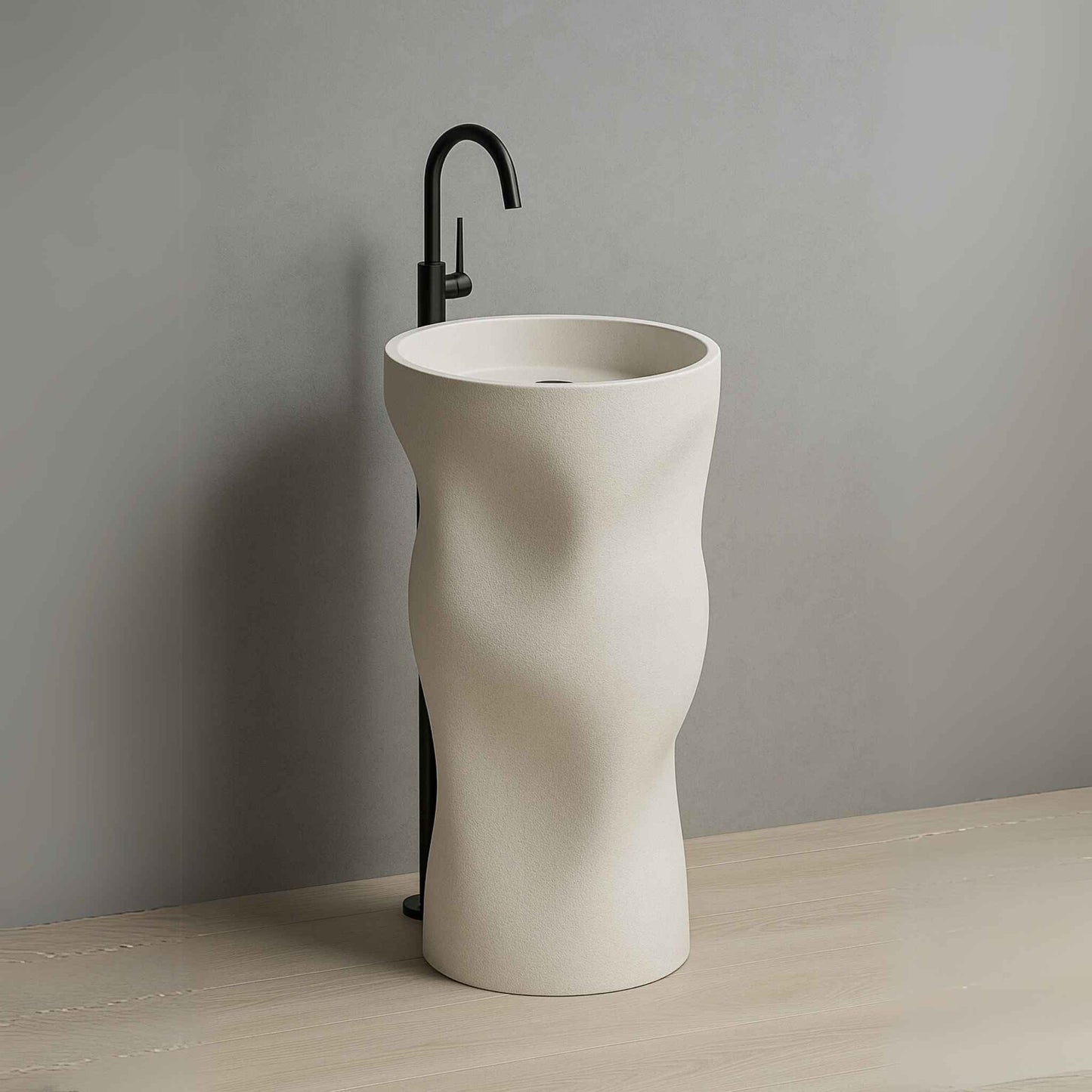 Luxury sculpted pedestal washbasin in matte ivory finish with wall-mounted black faucet placed in a high-end bathroom setting side angle