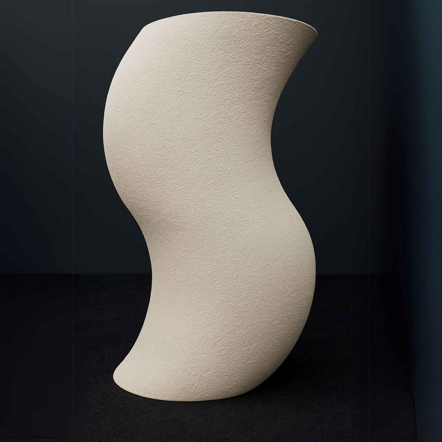 Sculptural freestanding beige stone washbasin in luxury bathroom setting front angle.