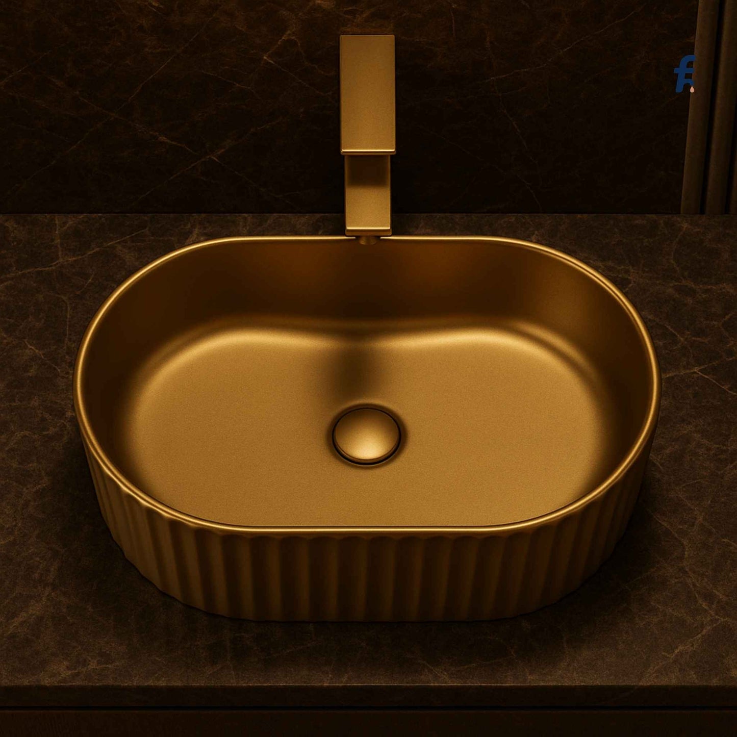 Gold sink with faucet on a dark brown textured wall
