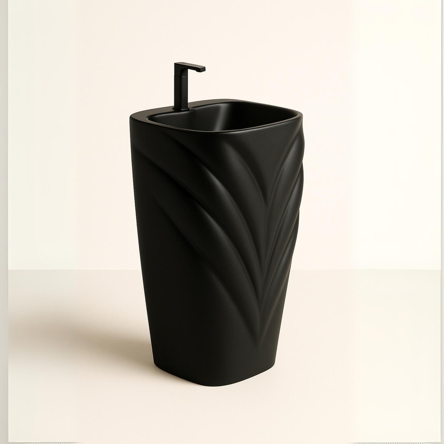 Side view of matte black pedestal washbasin with leaf contours