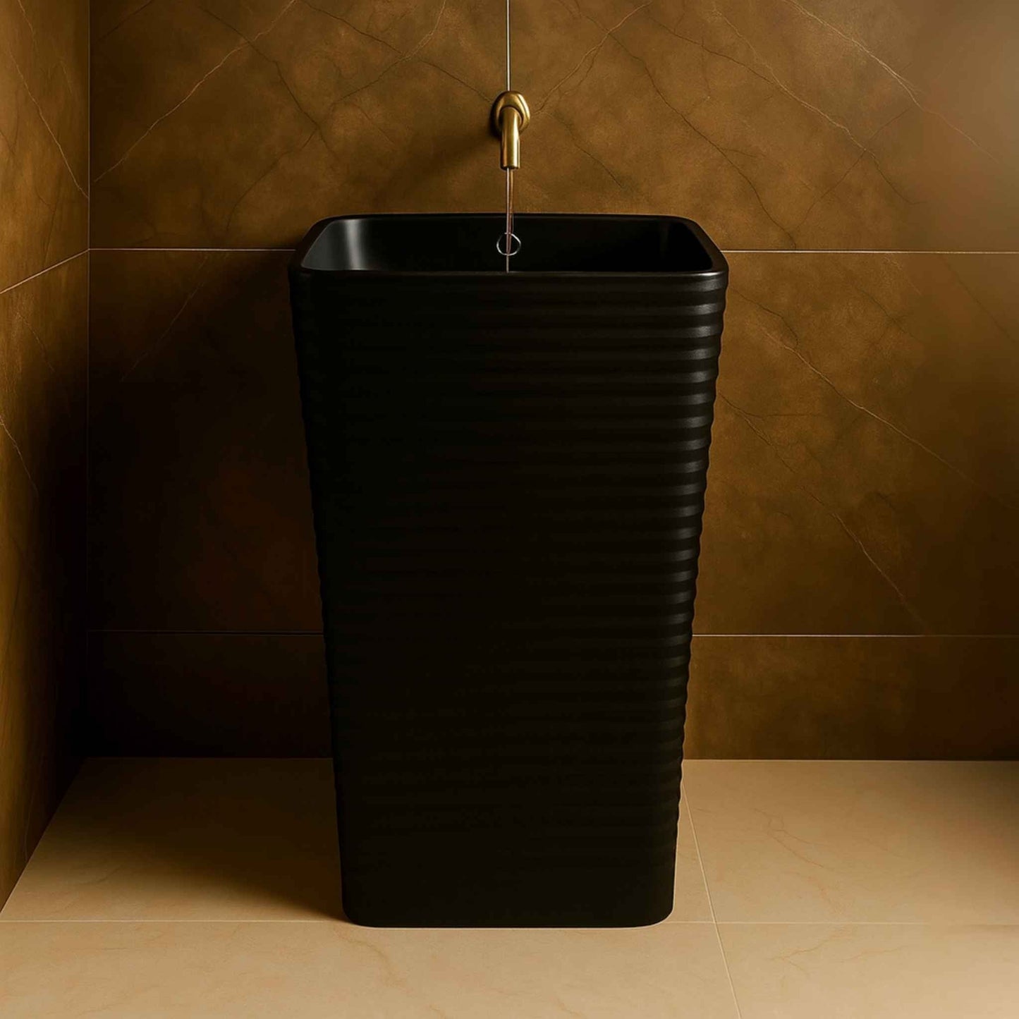 Front view of a matte black freestanding pedestal wash basin with ribbed design and gold faucet in a luxurious modern bathroom.