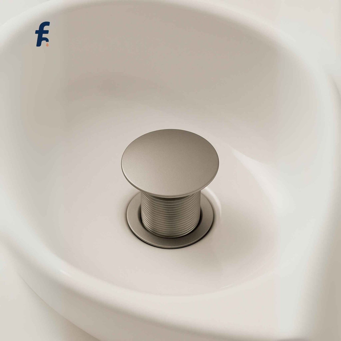 Pop-up waste coupling installed in white ceramic basin