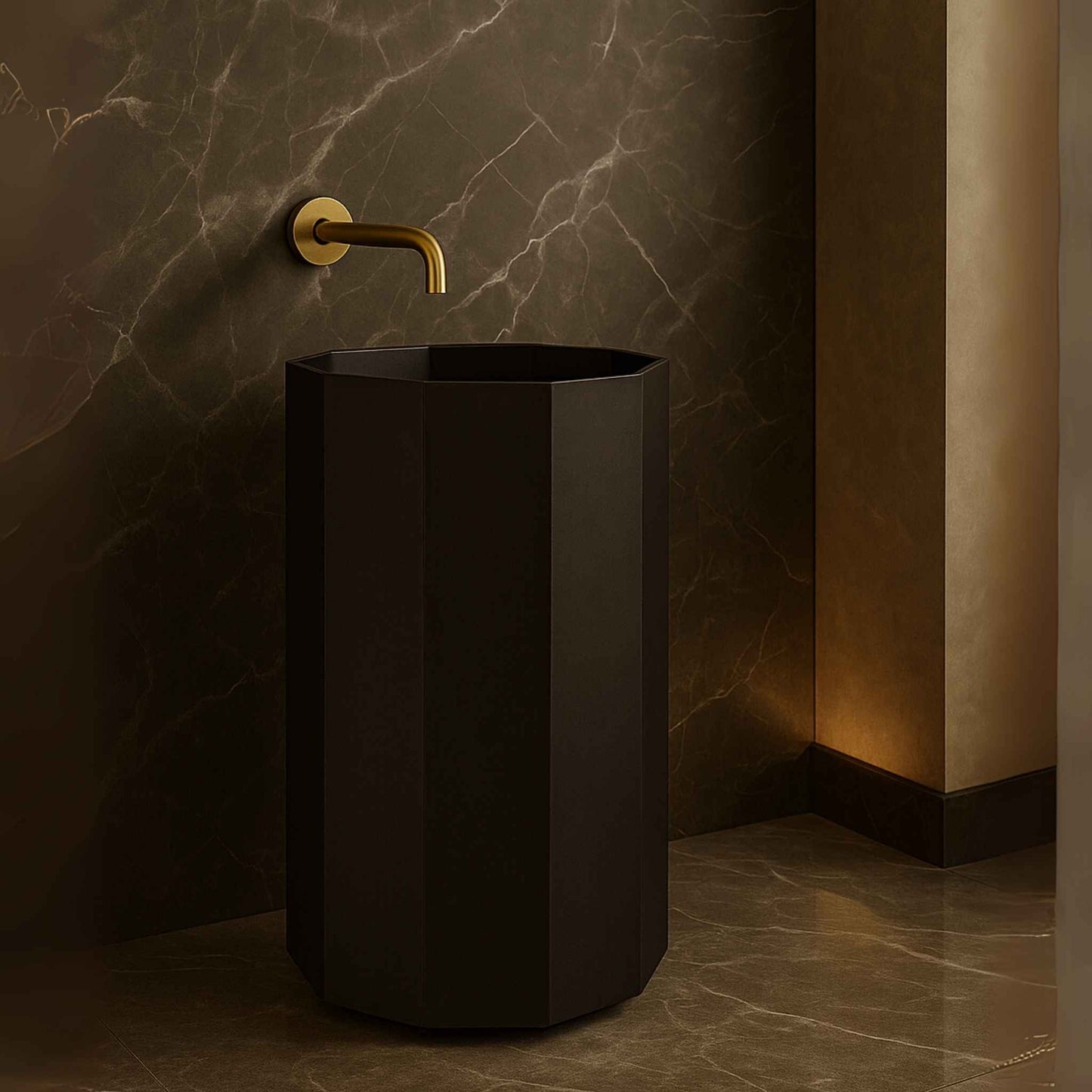 Black freestanding sink with gold faucet against a marble wall.