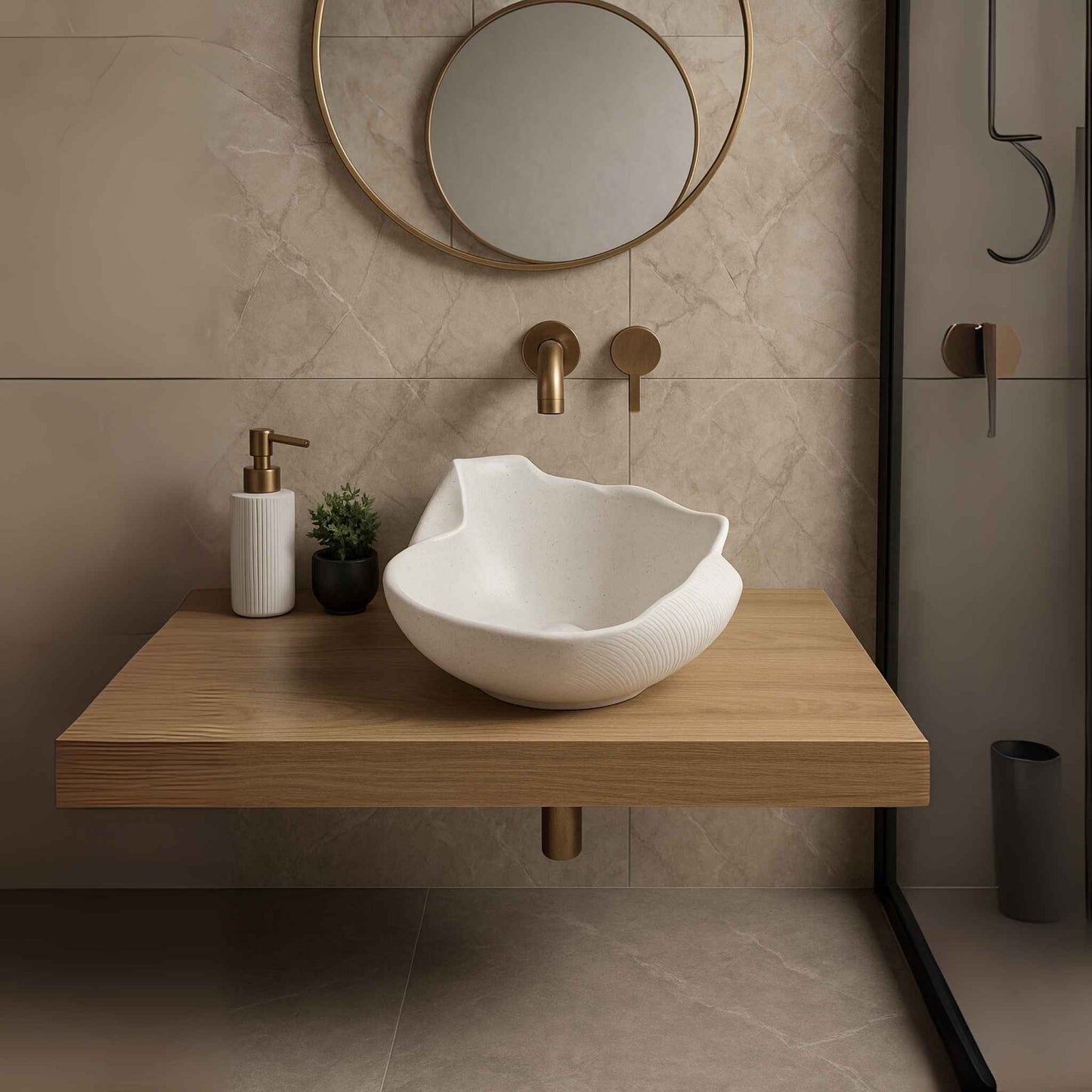 Modern bathroom with a white sink on a wooden vanity, gold fixtures, and decorative elements.