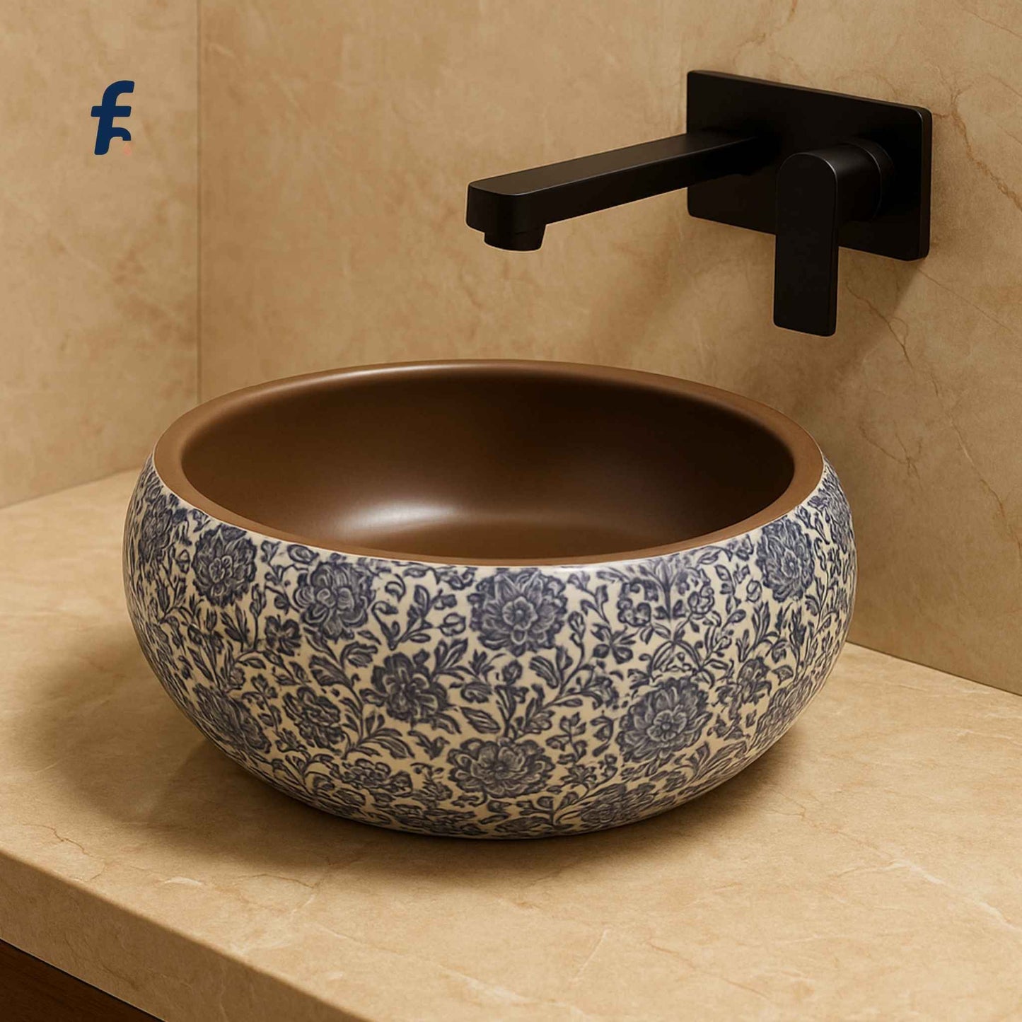 Decorative ceramic sink with floral pattern on a beige countertop with a black faucet.
