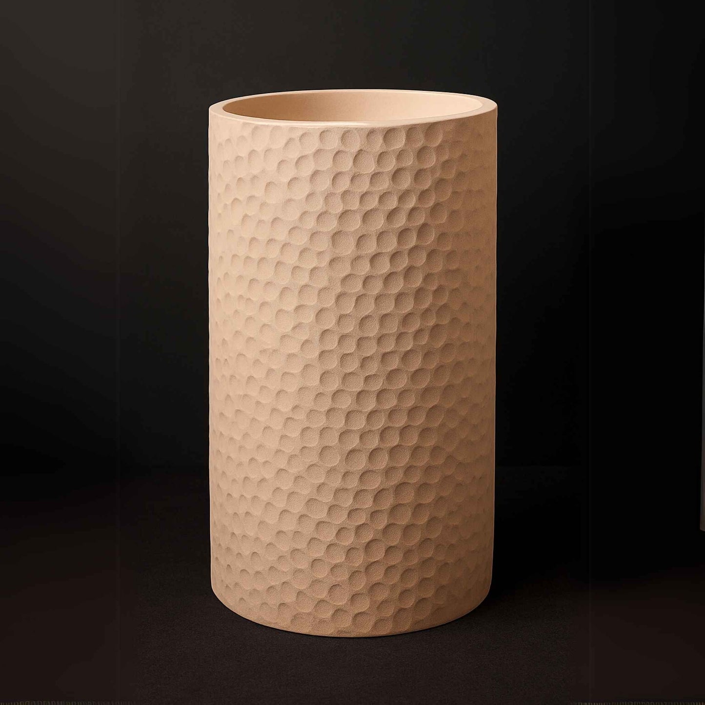 Front angle of freestanding beige pedestal washbasin with pebble texture