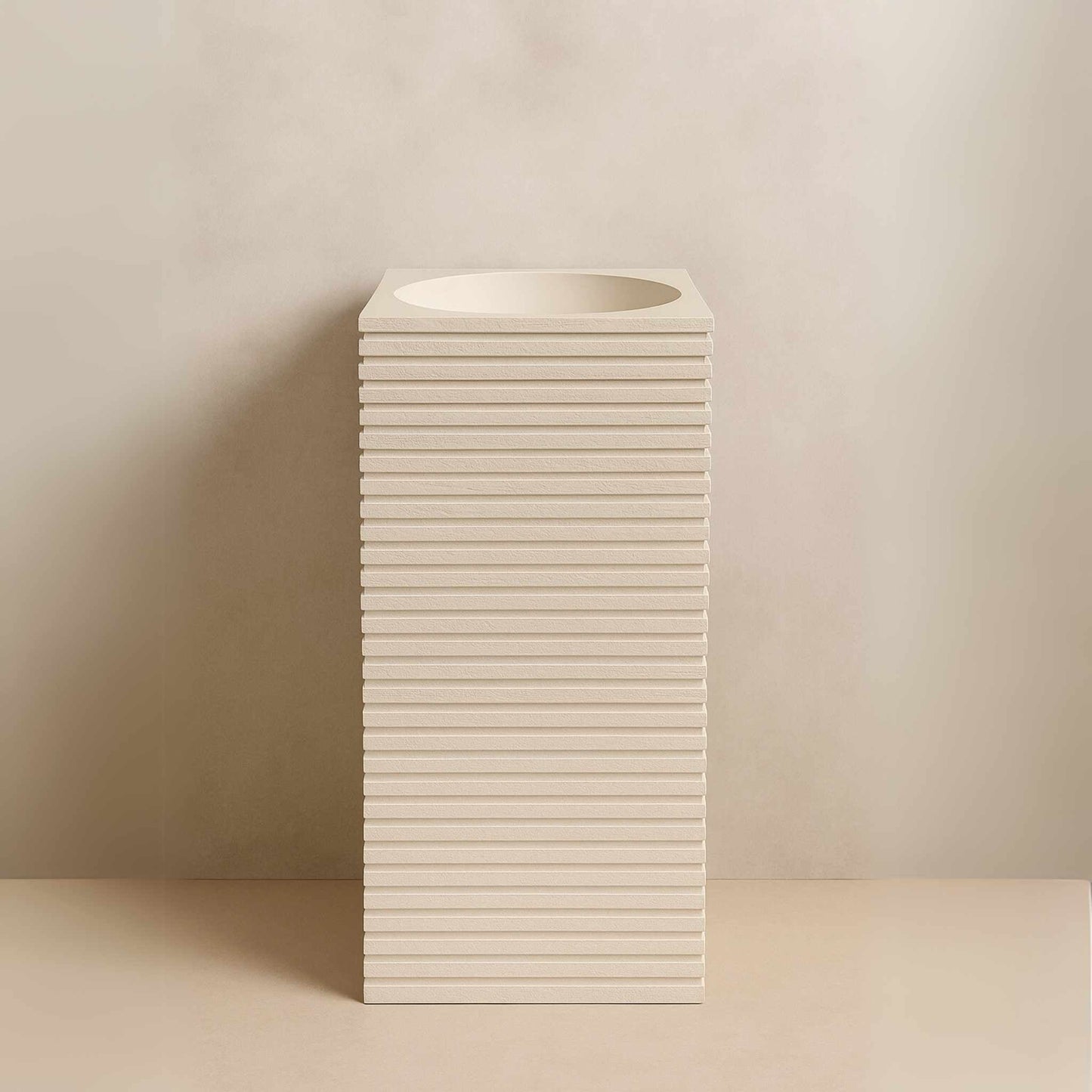 Front view of textured off-white pedestal basin with stacked design
