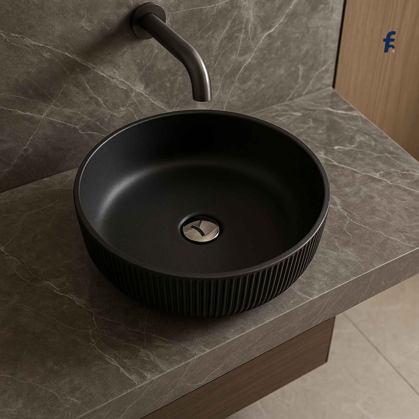Top angle of round matte black glass wash basin with chrome drain and marble countertop
