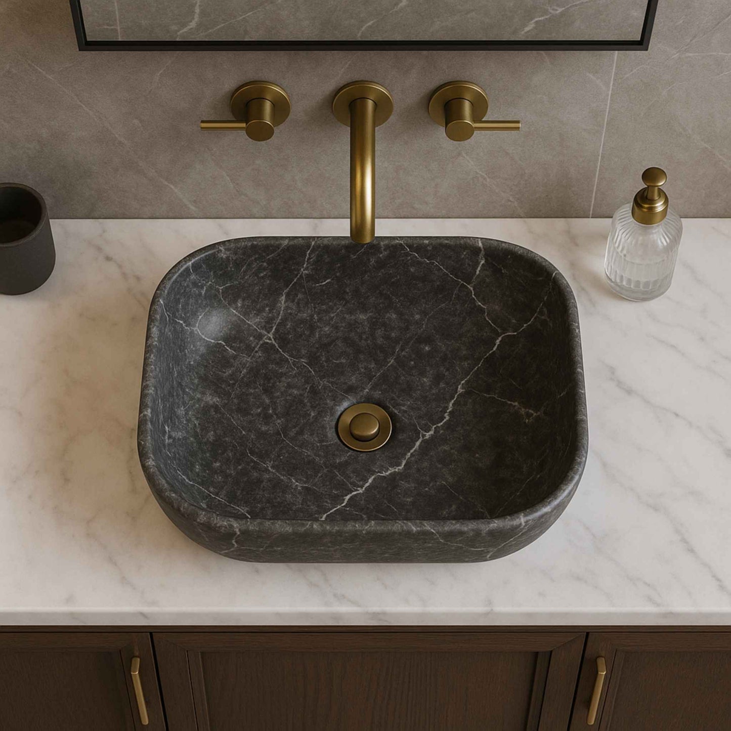 Top view of dark marble look ceramic wash basin with brushed brass faucet on luxury vanity
