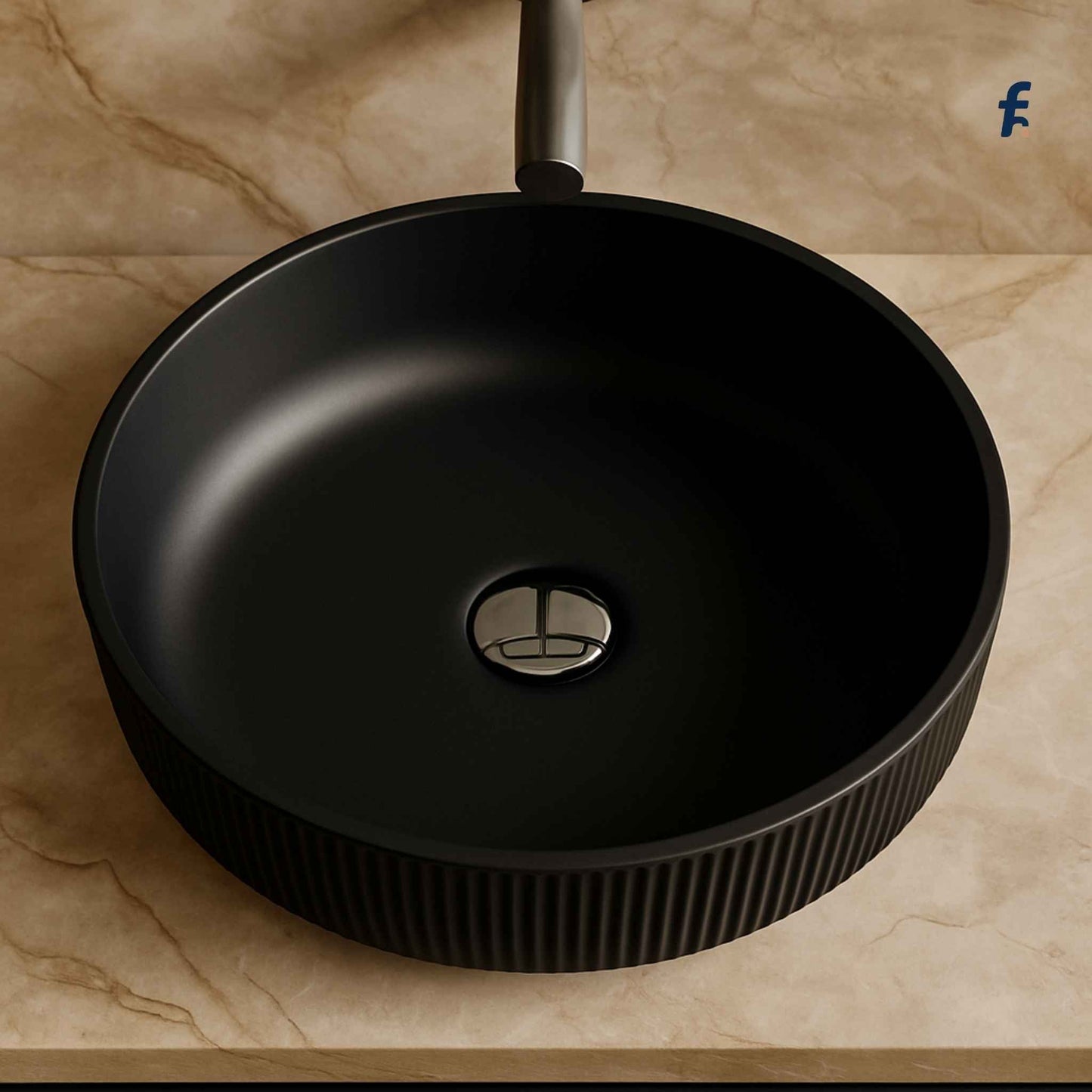 Detailed top-down view of textured matte black vessel sink on beige marble surface