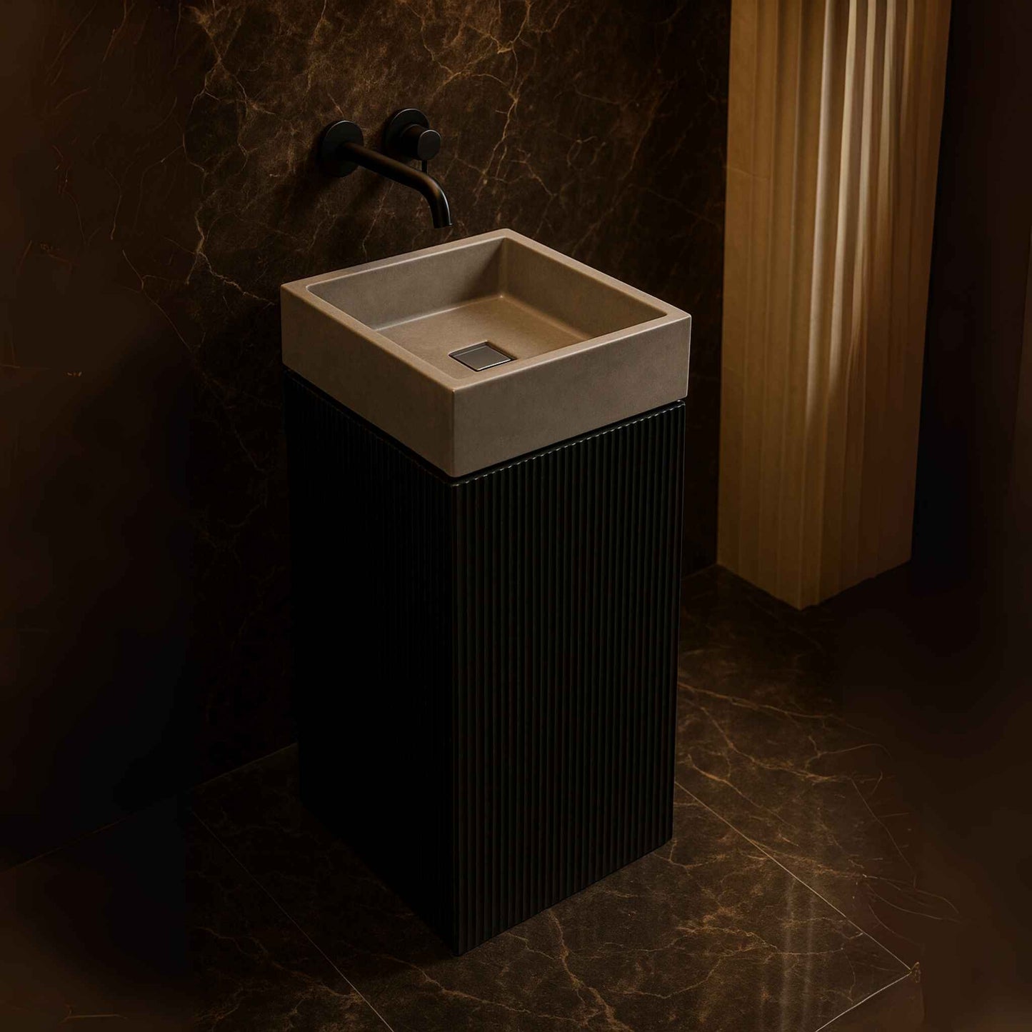 Top angle view of a freestanding black fluted pedestal washbasin with a sleek grey concrete bowl and wall-mounted black faucet.