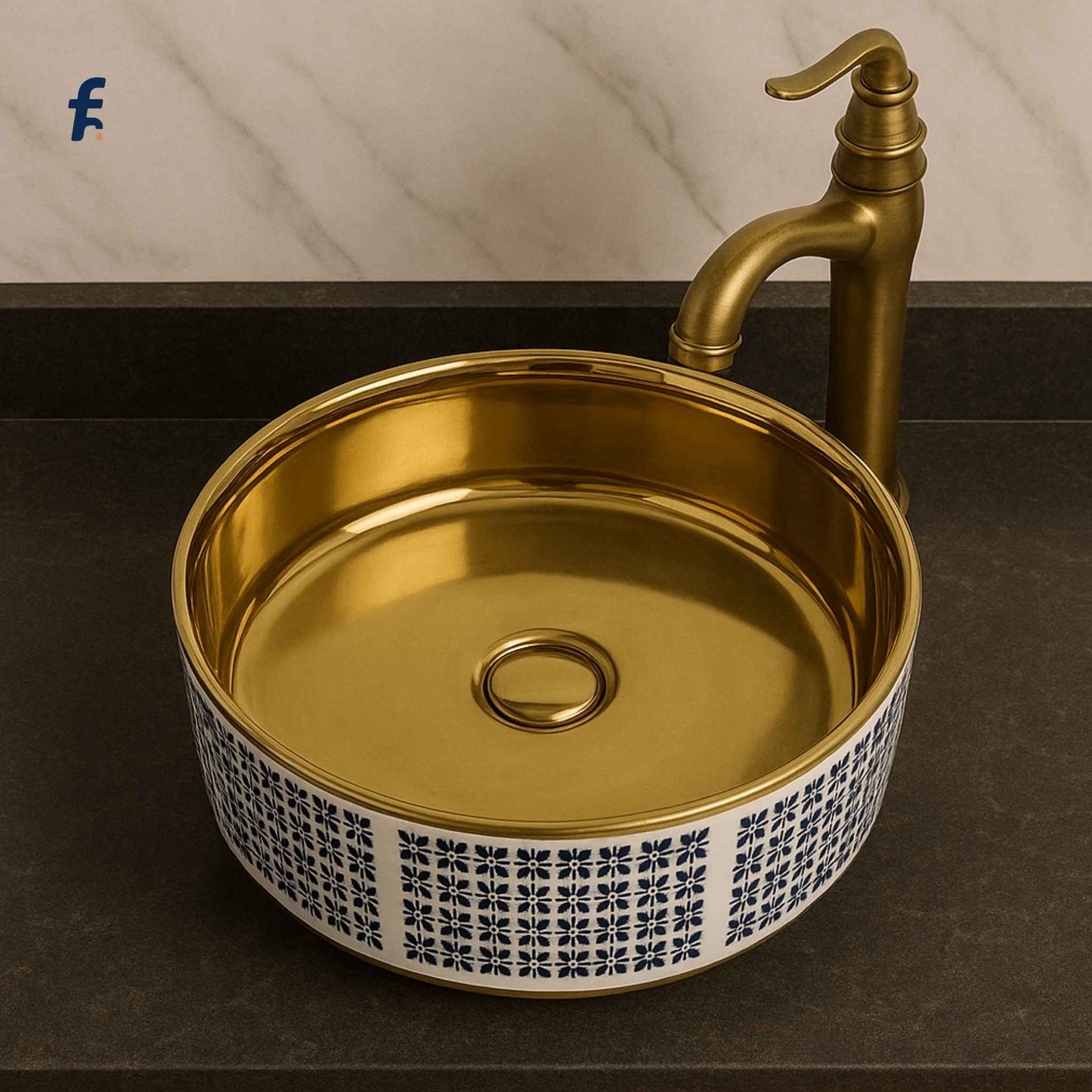 Gold sink with decorative patterned base and matching faucet on a dark countertop.