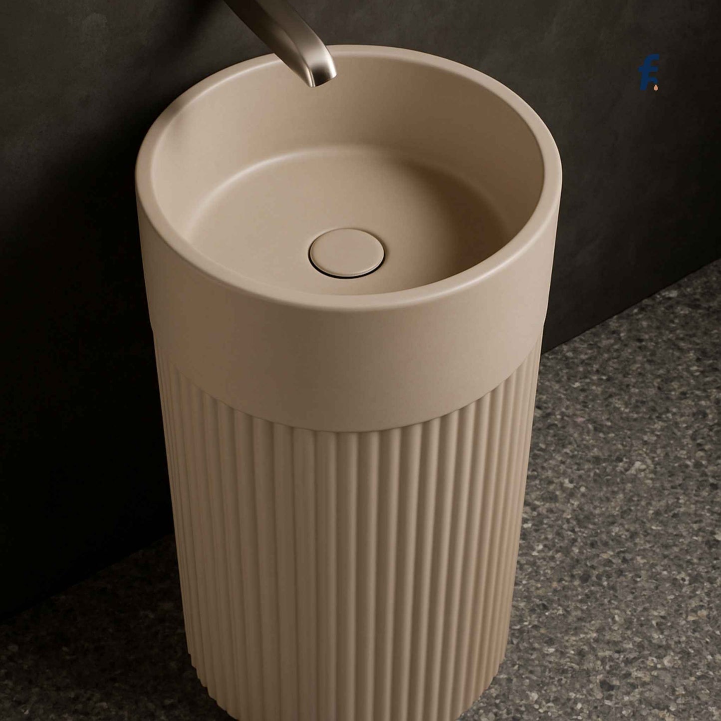 Beige freestanding sink with ribbed design on a dark background