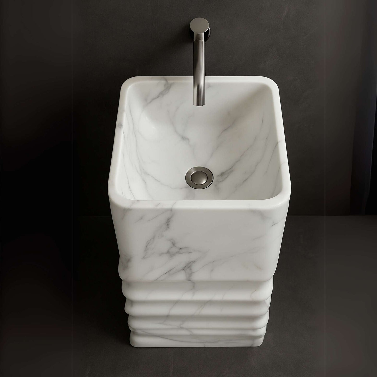Top-down view of marble pedestal basin showing inner bowl and gray veining with chrome faucet