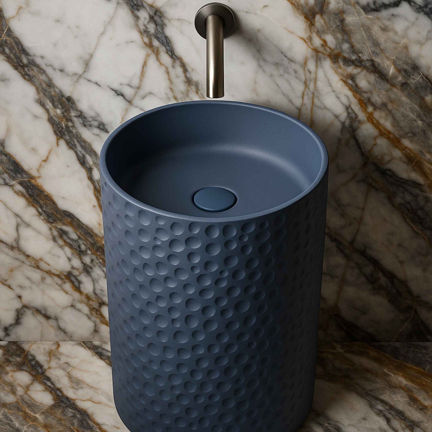 Top-down view of freestanding blue basin with wall-mounted faucet and Italian marble backdrop