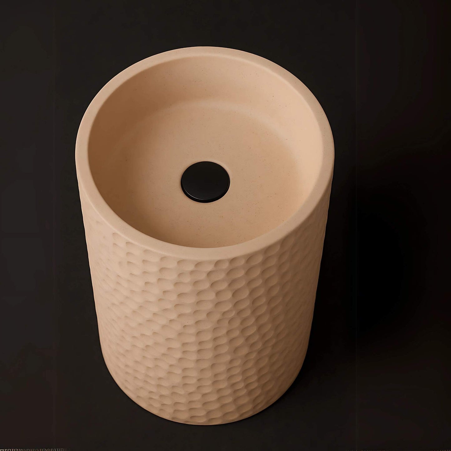 Top-down view of cylindrical basin with black drain and smooth interior