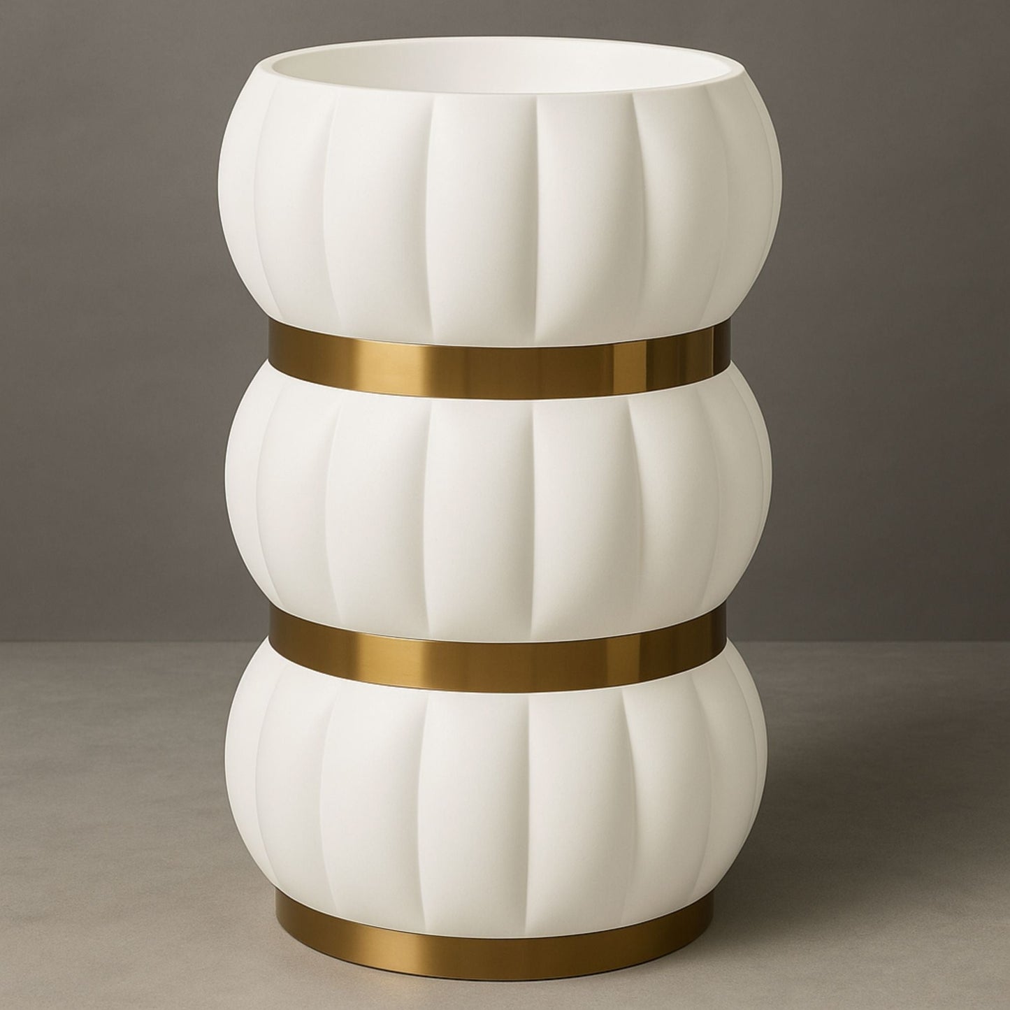Front view of white sculptural pedestal basin with gold accents