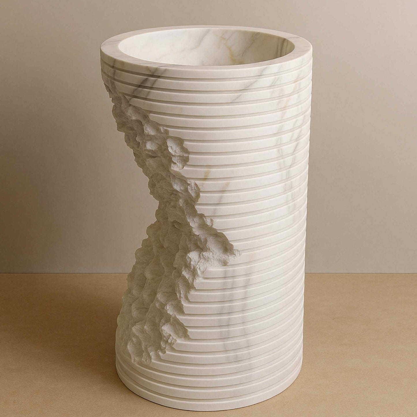 Front view of white marble pedestal basin with grooved and broken texture