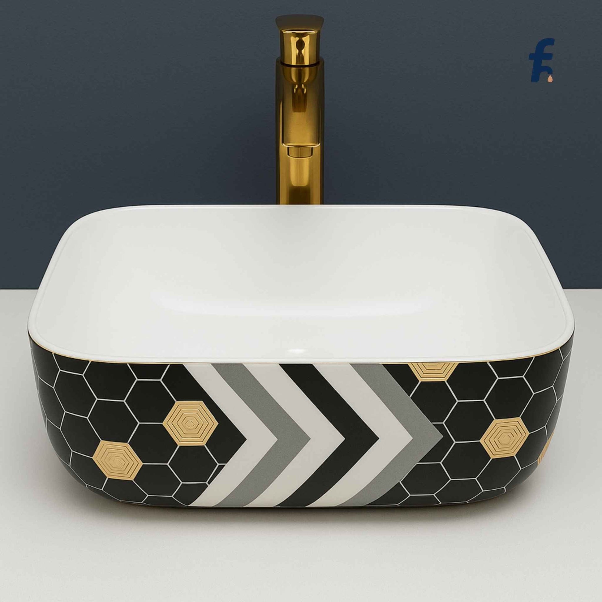 Decorative bathroom sink with geometric pattern and gold faucet against a dark background Front view of T 4001 geometric ceramic wash basin